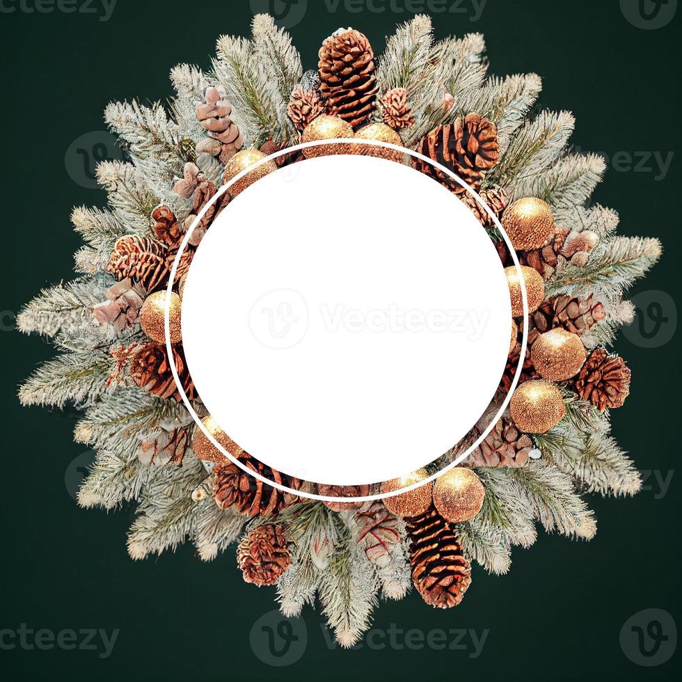 Christmas wreath made of pine branches and golden ornaments. photo