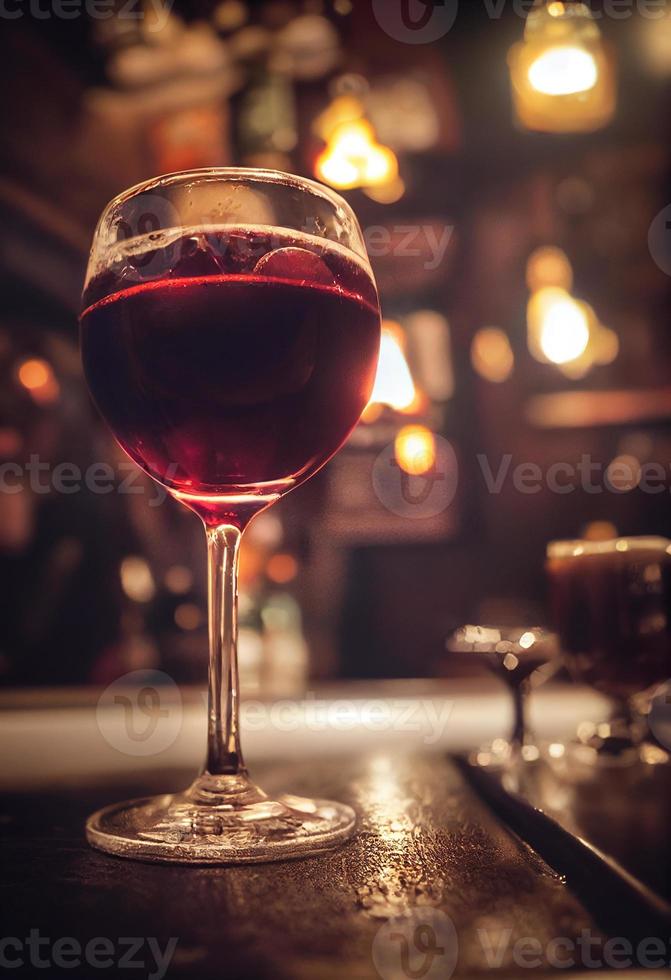 Glass of red wine in a pub with blurred back photo