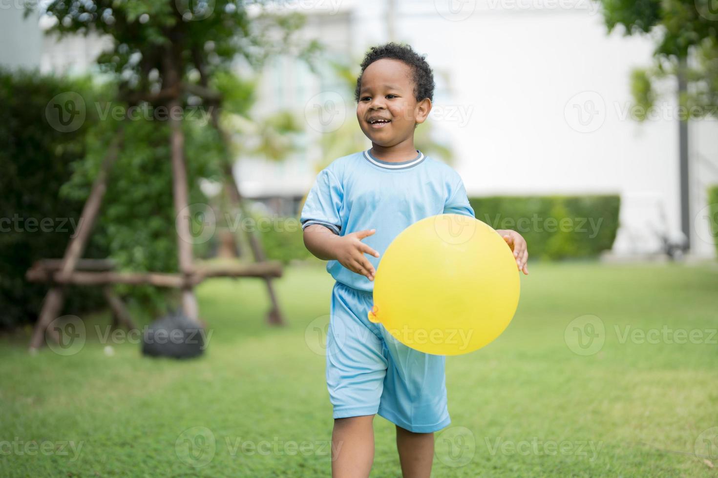 Cute little boy with balloons in the park on a clear day. photo