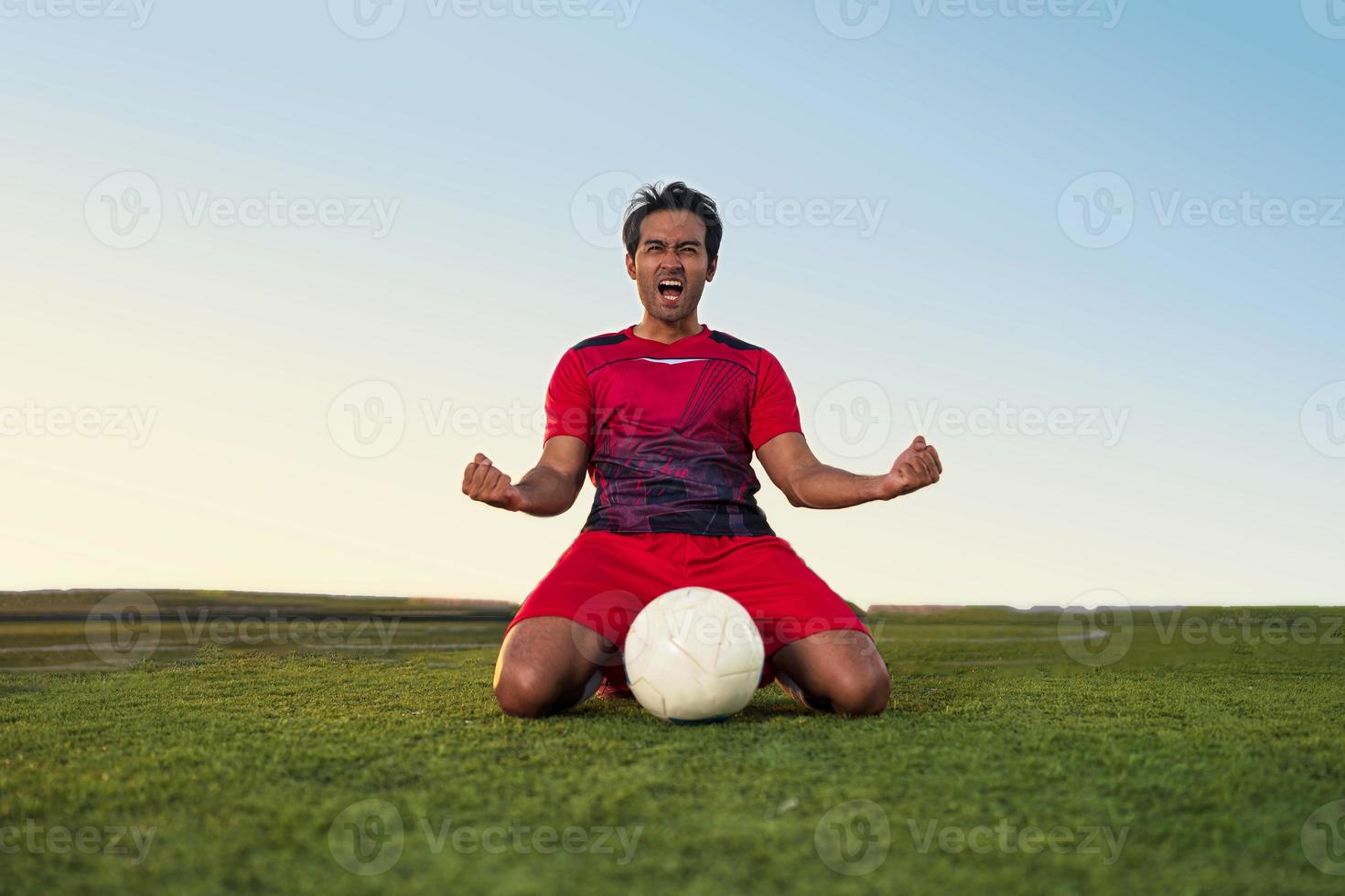 Young footballer Show excitement and joy after winning and celebrating success photo