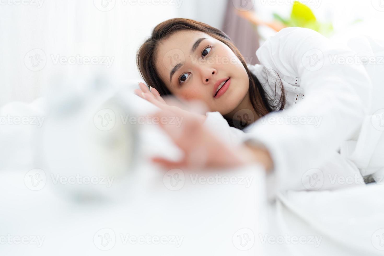 Alarm clock with good day against background happy young woman. photo