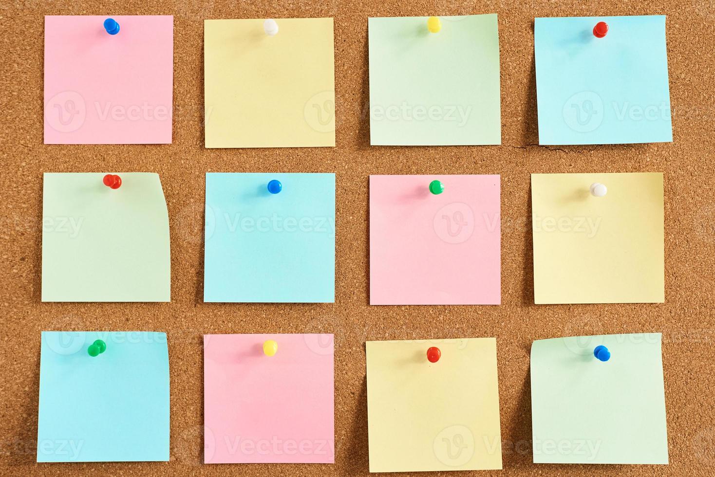 Cork board with a pinned colored blank notes photo