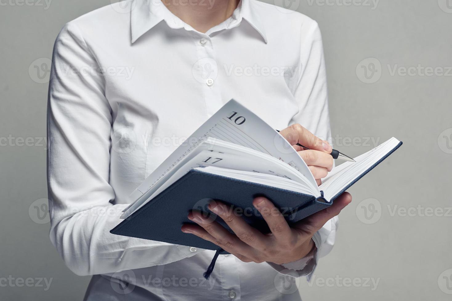 Businesswoman with organizer diary in her hands photo