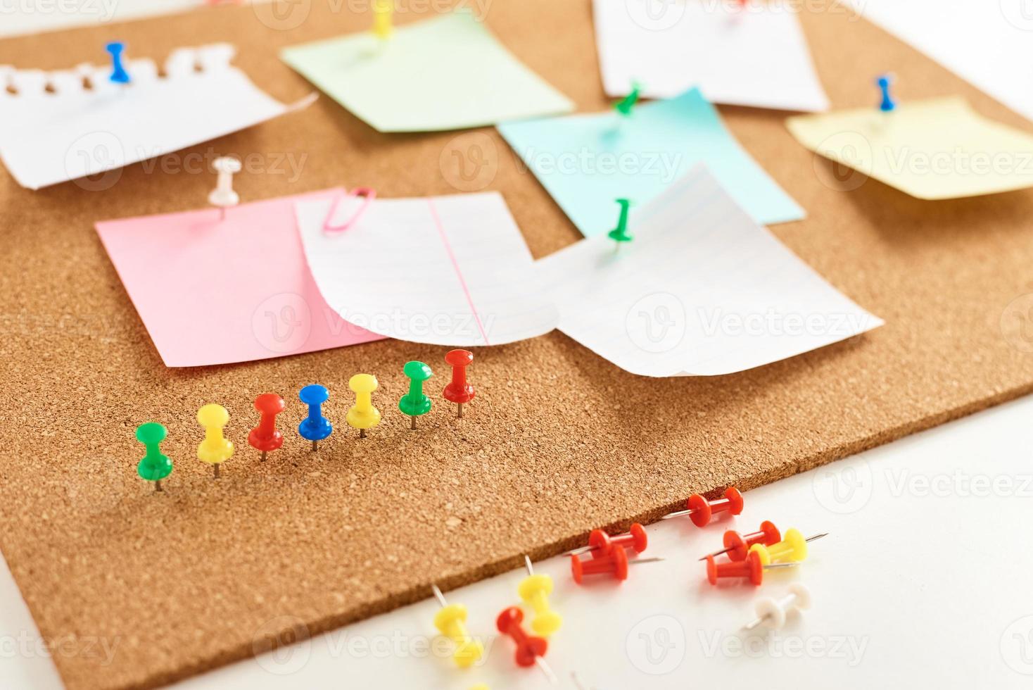 Cork board with a pinned colored blank notes photo