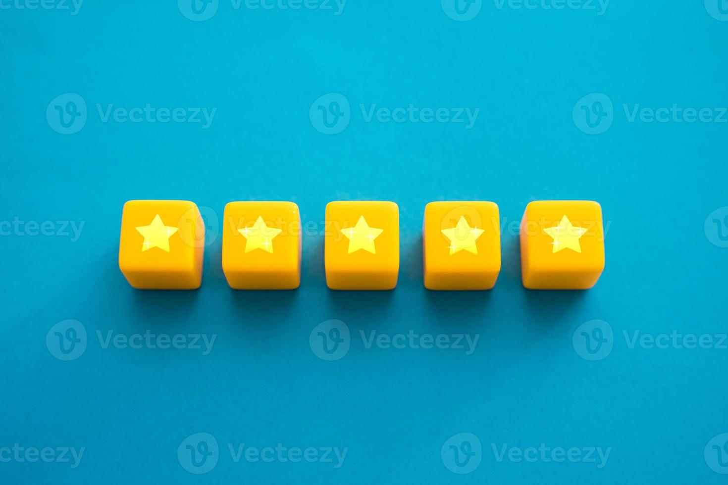 Five stars in a row on yellow blocks. Evaluation of the quality of the provided service. Feedback overview. Popularity, prestige. High reputation. Successful business, satisfied customers. photo