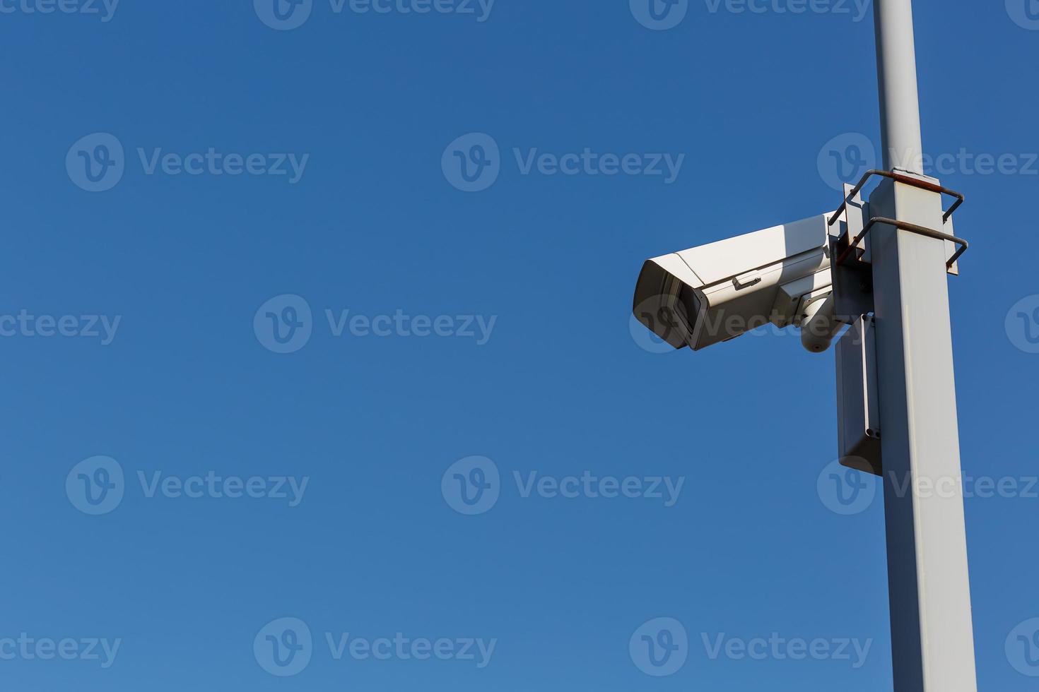 Security camera on blue sky background. Security view post photo