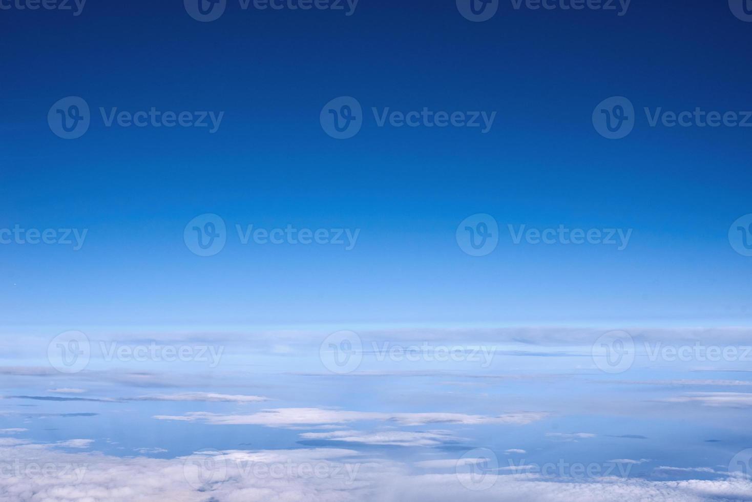 cielo azul sobre las nubes desde la ventana del avión foto