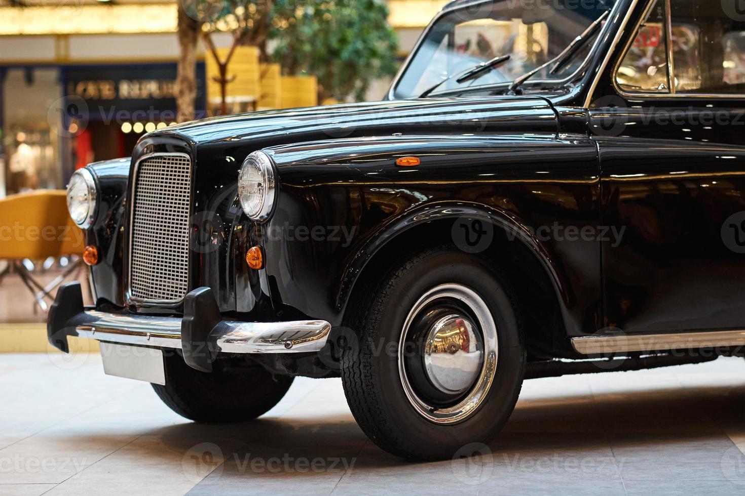 Closeup of a black vintage car. Front view of retro car photo