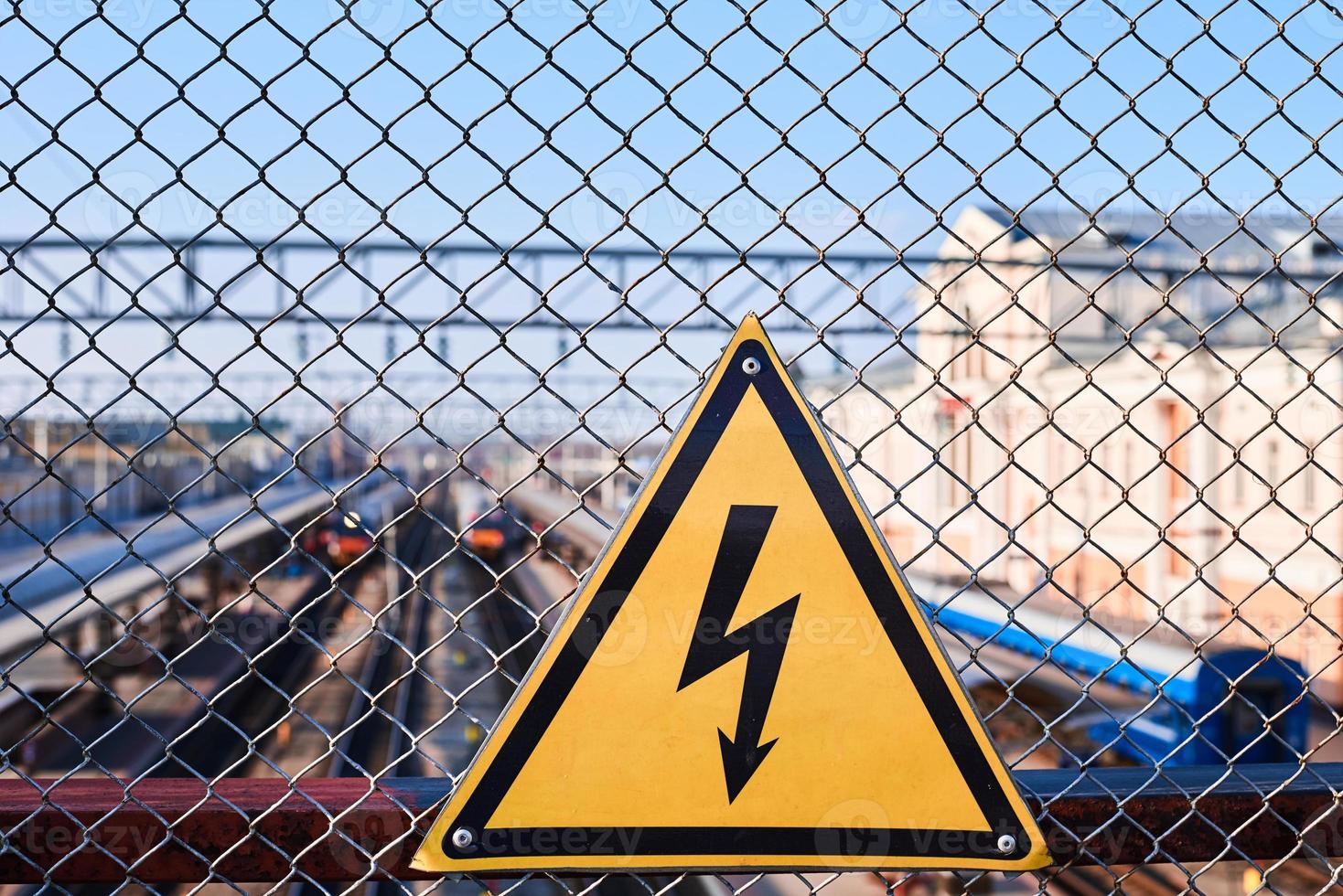 señal de peligro eléctrico. electricidad de alto voltaje en una estación de tren foto