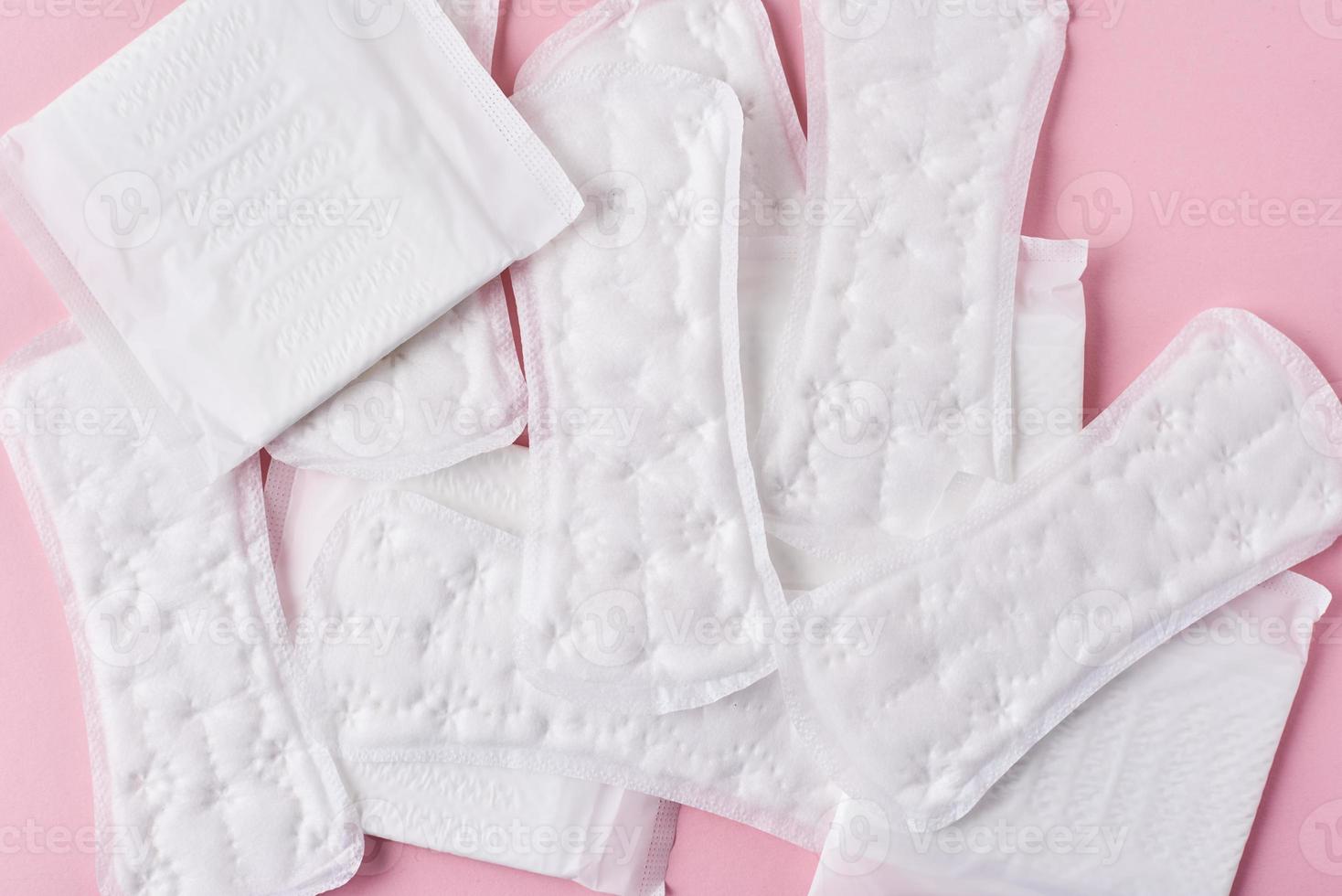 Sanitary pads on a pink background, top view photo
