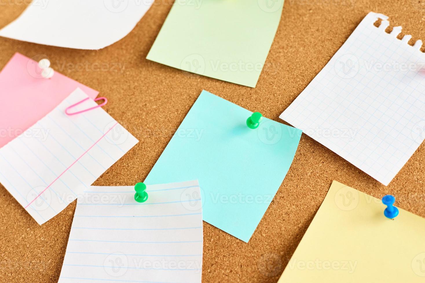 Cork board with a colored paper blank notes, close up photo