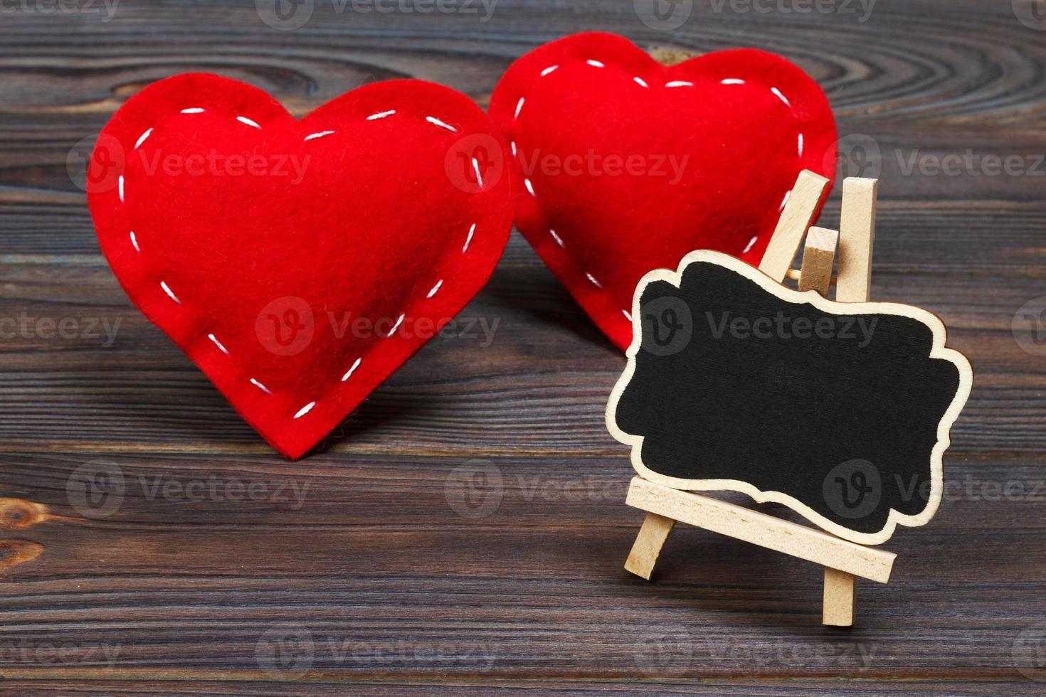 Blackboard on wooden background with red heart. Copy space photo