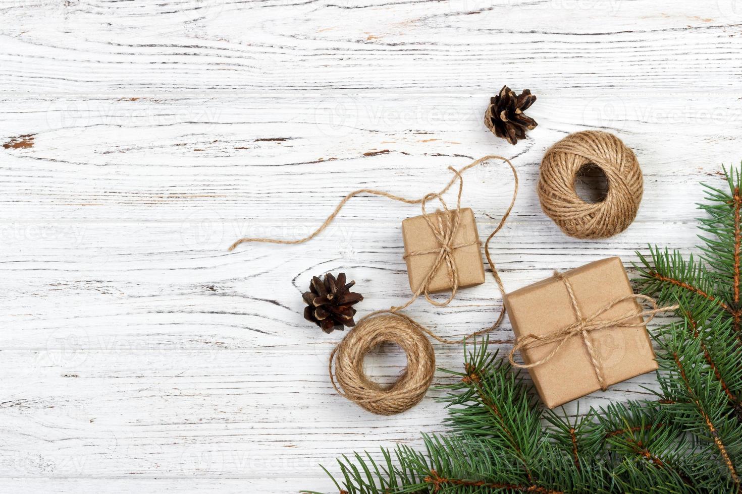 Pile of Christmas wrapped presents with twine string roll, fir tree branch,  Christmas toy star at wooden background. Xmas decoration, cozy festive  Stock Photo - Alamy