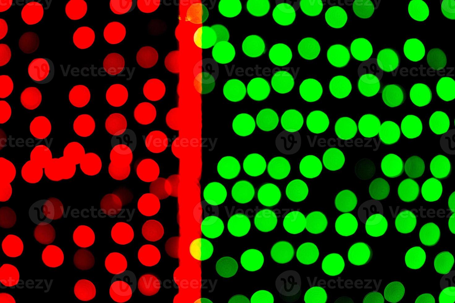 Unfocused abstract green and red bokeh on black background. defocused and blurred many round light photo