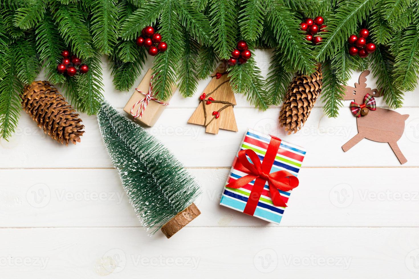 Top view of fir tree, New Year decorations, Christmas tree and present on wooden background. Time for holiday concept photo