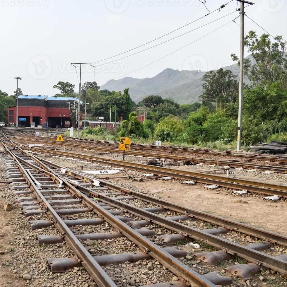 View of Toy train Railway Tracks from the middle during daytime near Kalka railway station in India, Toy train track view, Indian Railway junction, Heavy industry photo