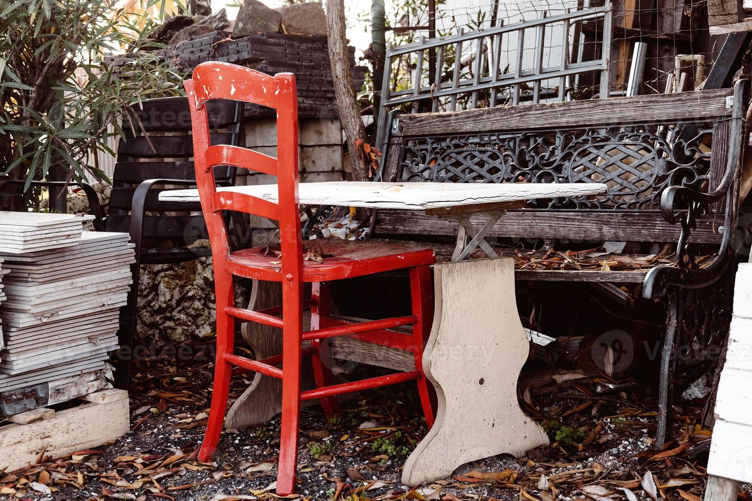 red decorative chair in a garden photo