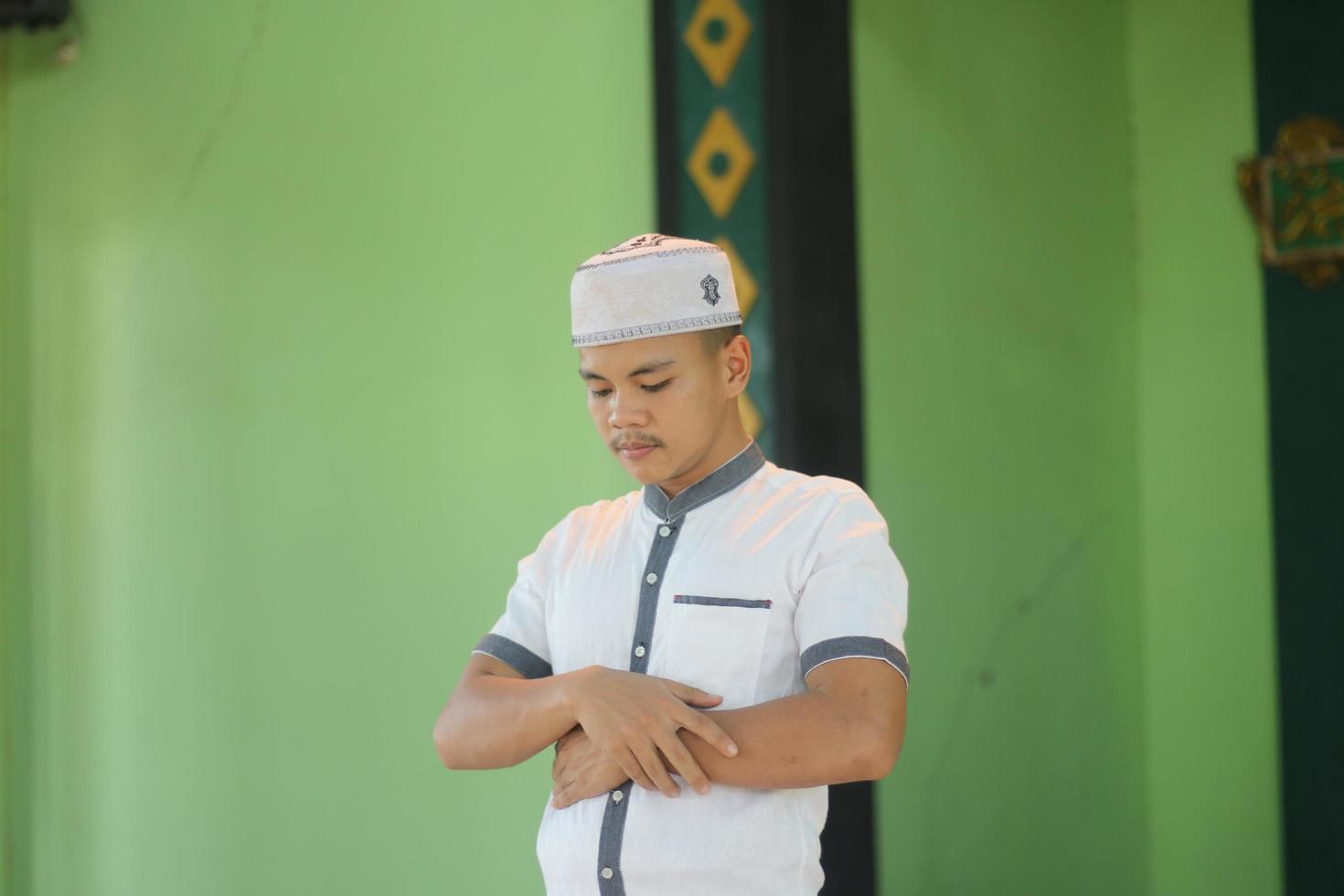 Young asian muslim praying in the mosque photo