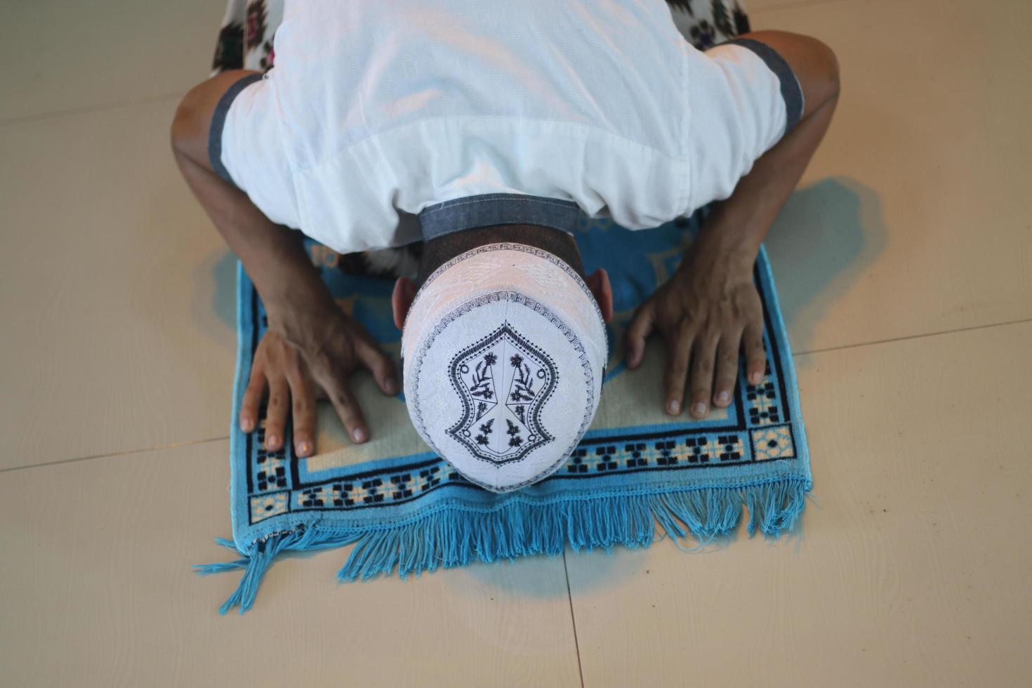 Young asian muslim praying in the mosque photo