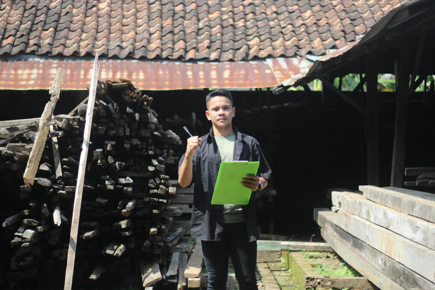 ASIAN YOUNG MAN BOSS OF WOOD COMPANY IS CHECKING QUALITY photo