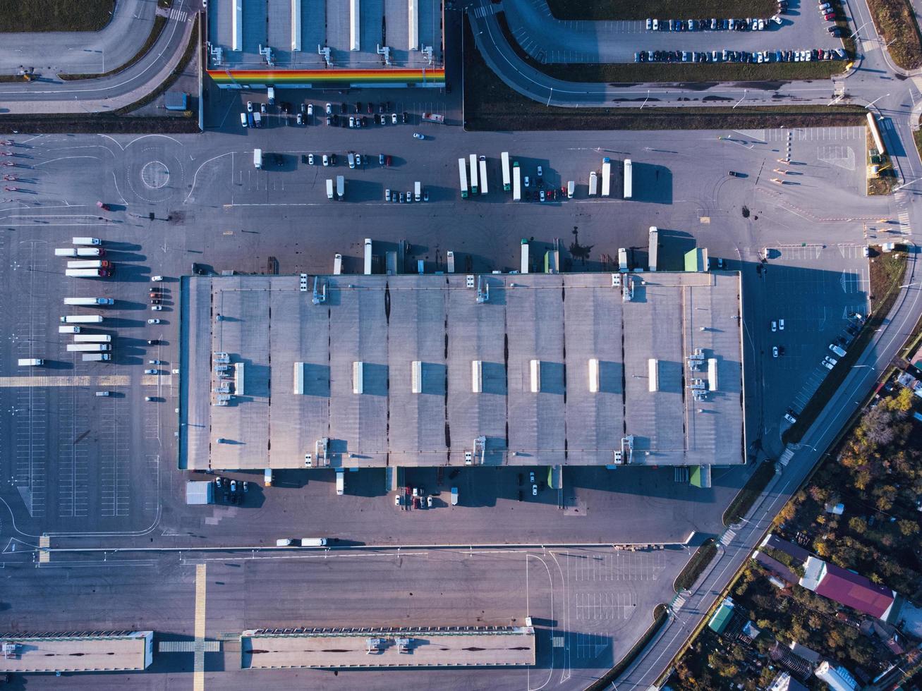 Aerial top down view of dock warehouse and trucks with semi-trailers. photo