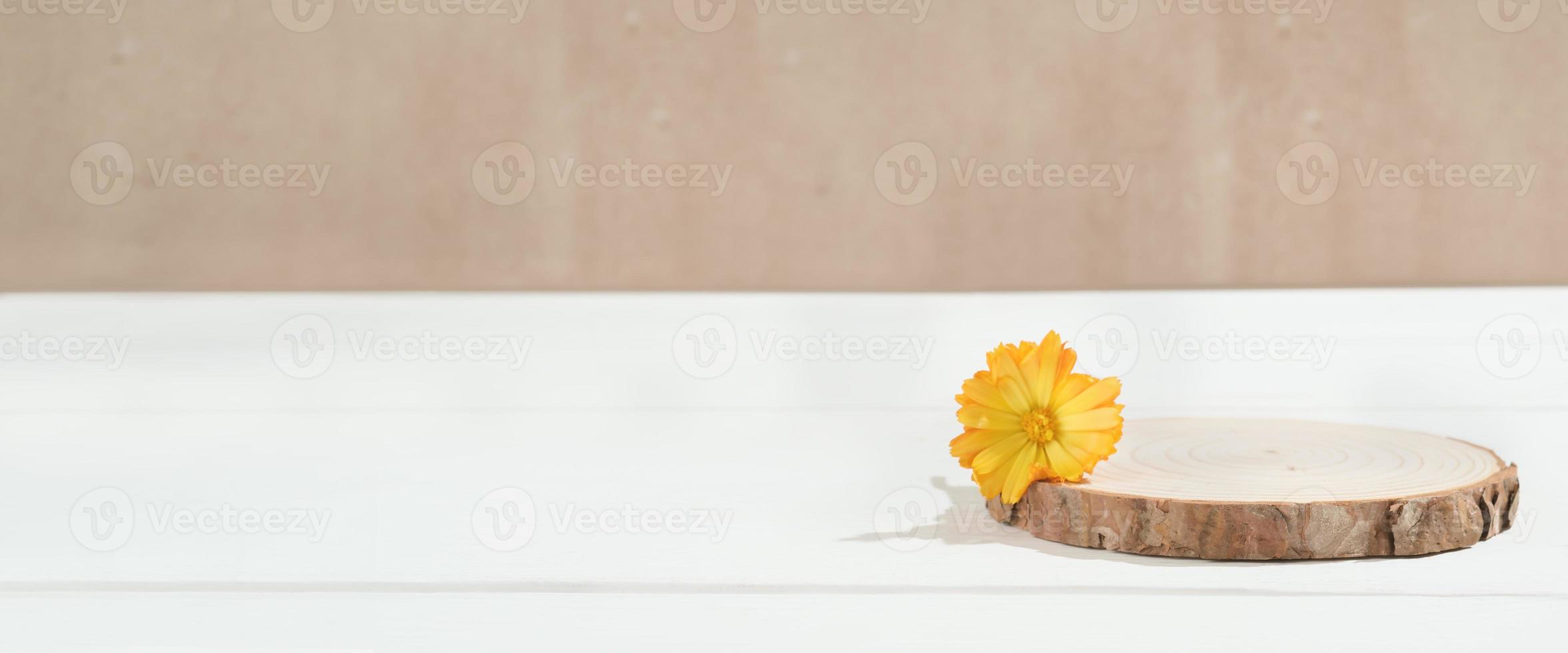 wooden round podium with flower decor. empty scene for product presentation, stand for packaging or marketing advertising, banner. photo