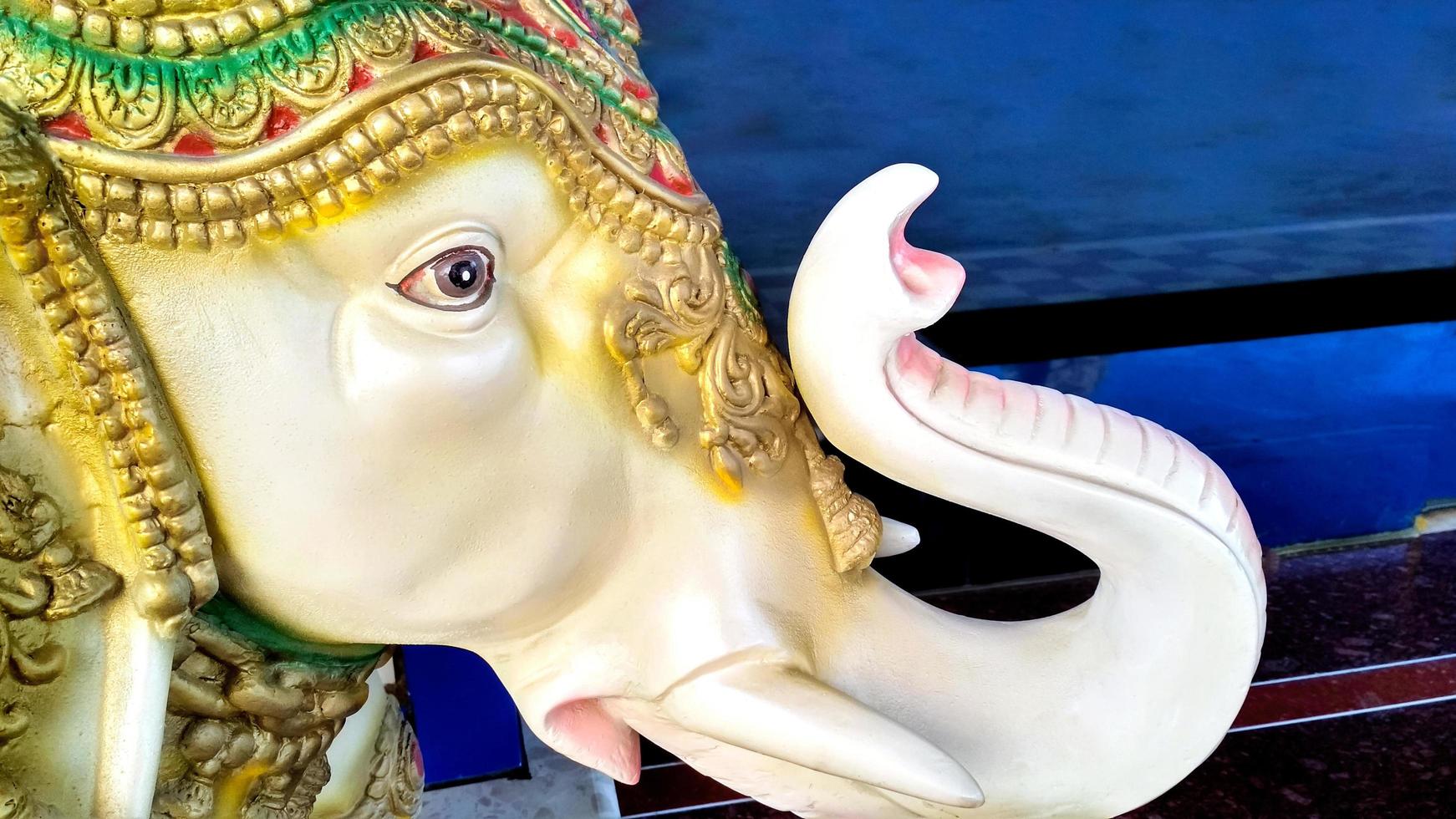 A decorated stone elephant placed at the gate of the house for decoration photo