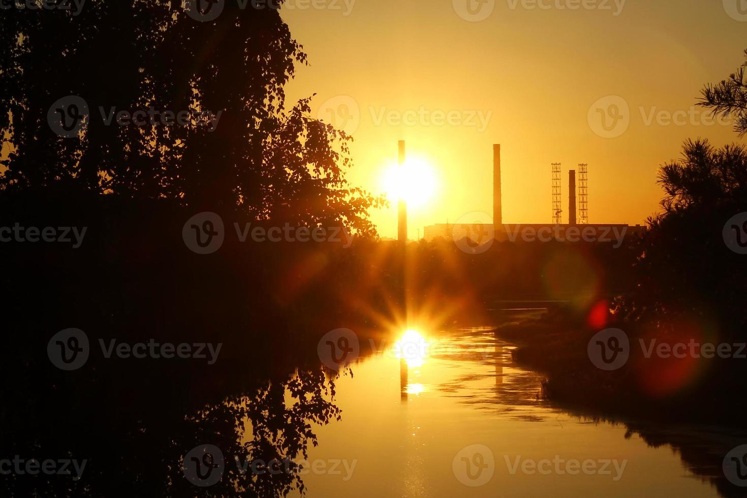 The sunset view on a river, a forest and colorful sky. photo