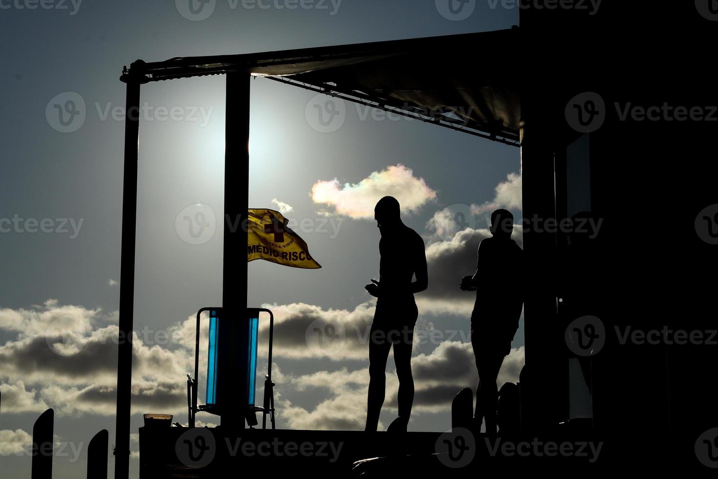 Rio de Janeiro, RJ, Brazil, 2022 - People in silhouette watch the sunset at Arpoador Rock, Ipanema Beach photo