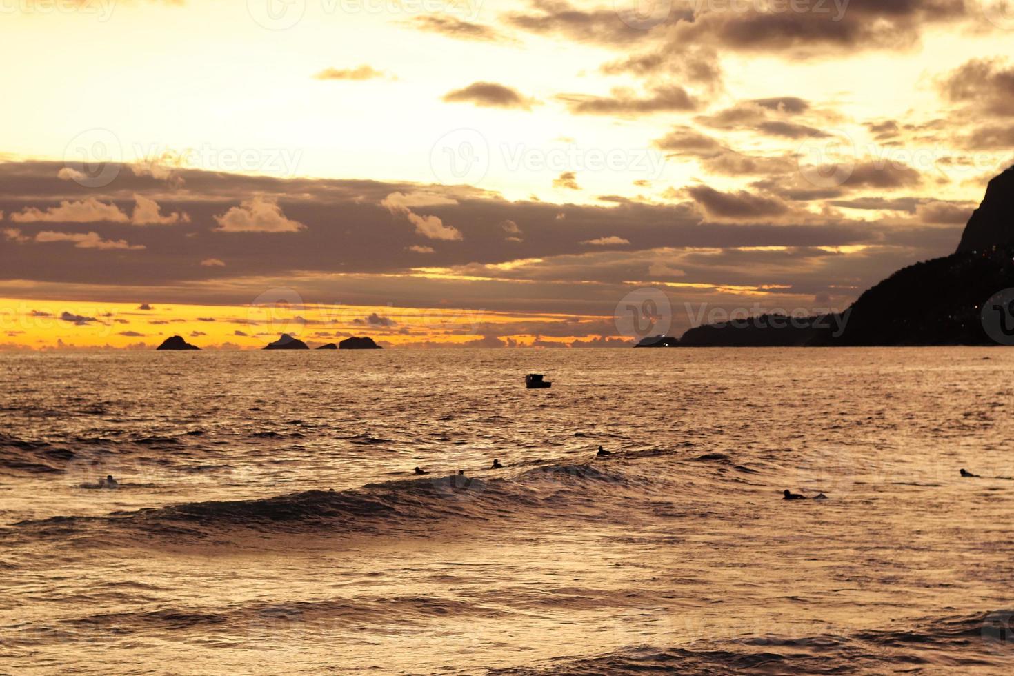 Rio de Janeiro, RJ, Brazil, 2022 - People in silhouette watch the sunset at Arpoador Rock, Ipanema Beach photo