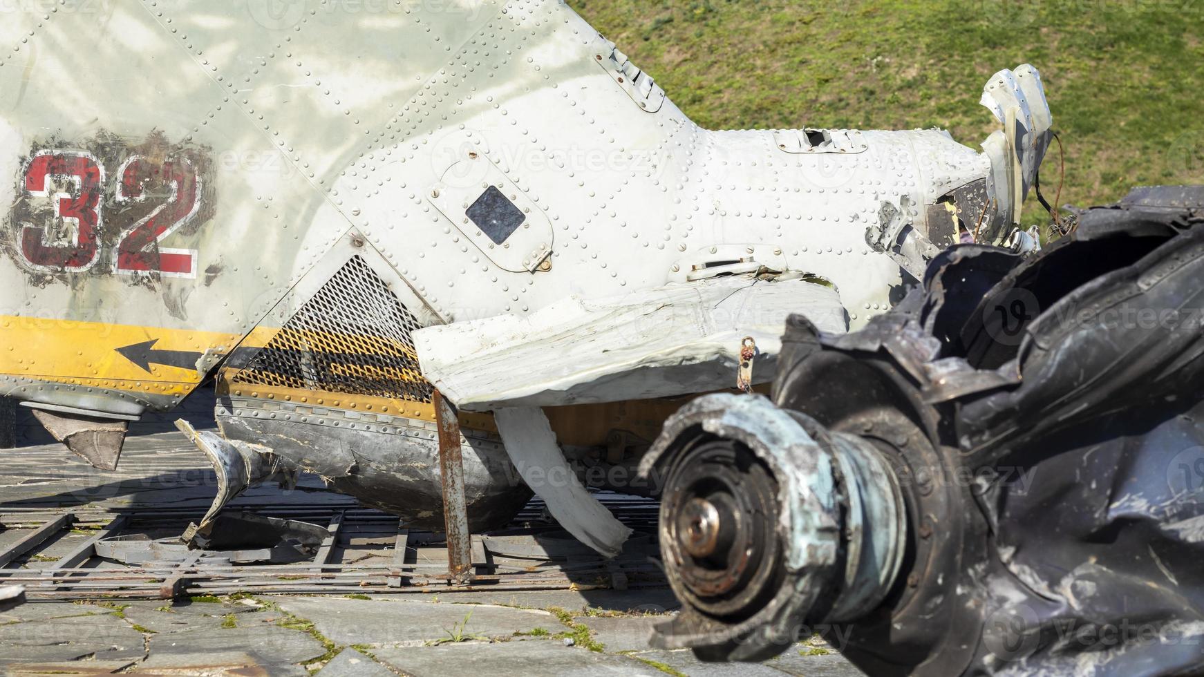 Burnt parts of the destroyed Russian Air Force combat helicopter Hind Crocodile. The wreckage of a downed helicopter. War in Ukraine. Broken military attack helicopter close-up. photo