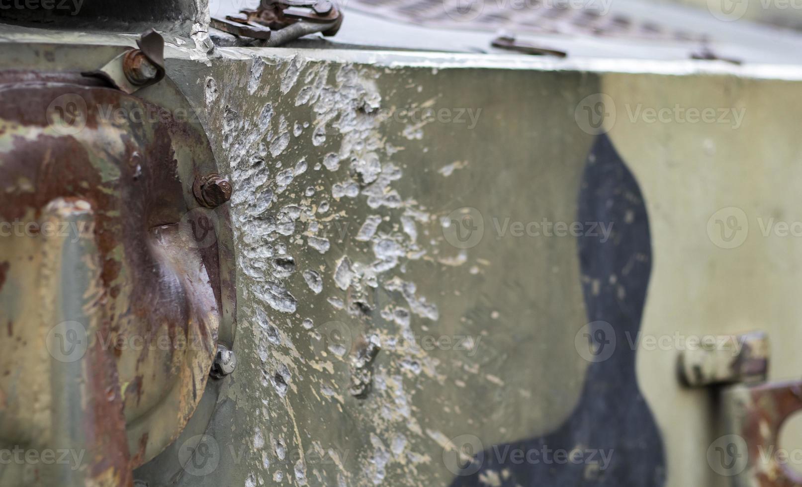 Russian combat vehicle, with holes in the armor. Destroyed military armored vehicles, disabled, blown up and destroyed. Armor metal background with bullet holes. Hole from cumulative penetration. photo
