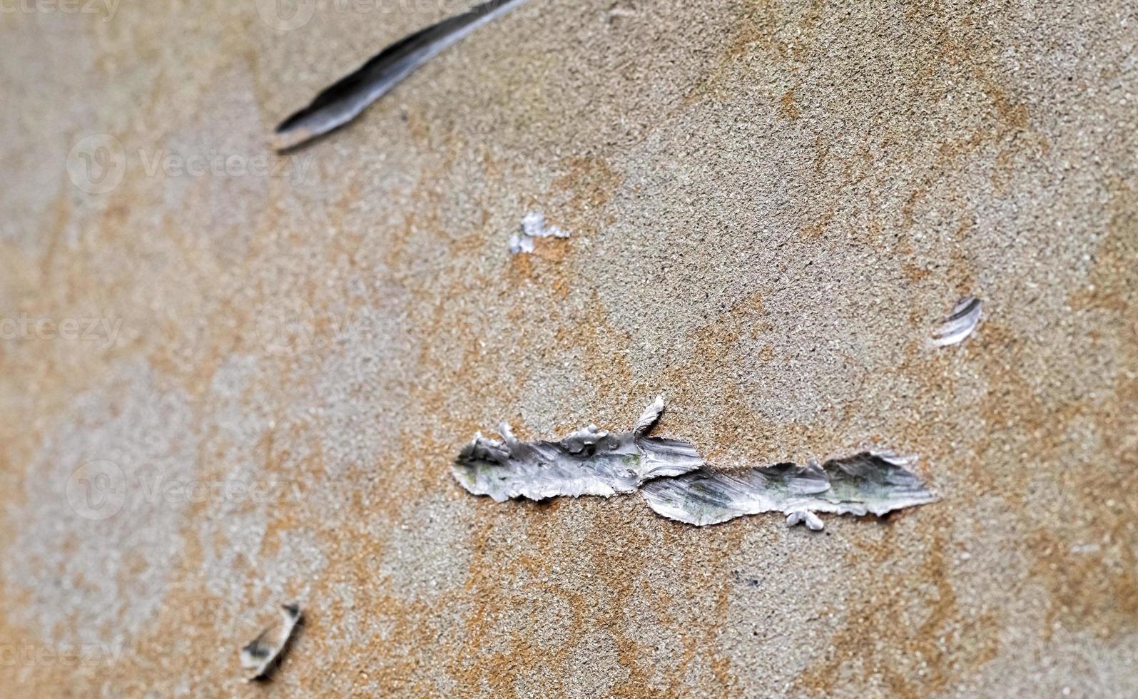 Texture of camouflage armored metal with damage close-up. Armor deformation from a shell close-up. Damaged armor of a Russian armored personnel carrier by shell fragments. War in Ukraine. photo
