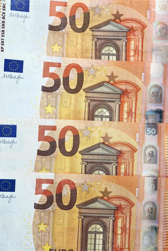 Close up of numerous euro banknotes lying on top of each other. photo