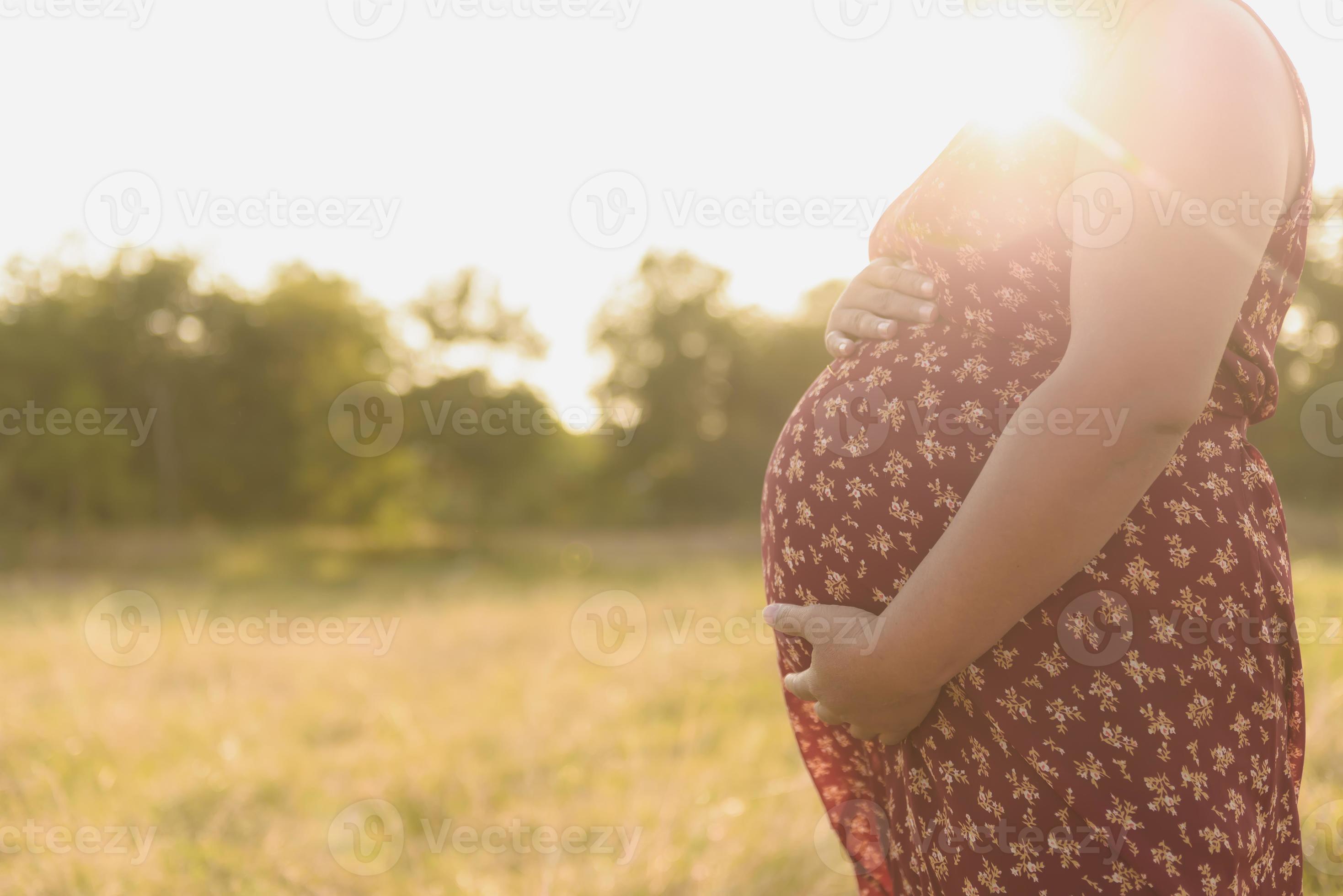 Pensive pregnant woman dreaming about child. Young happy expectant