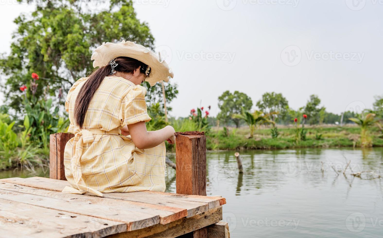 side view of the girl alone on the bridge The child is unhappy, feels pressured, thinks about the child's problems. The concept of depression in adolescence. photo