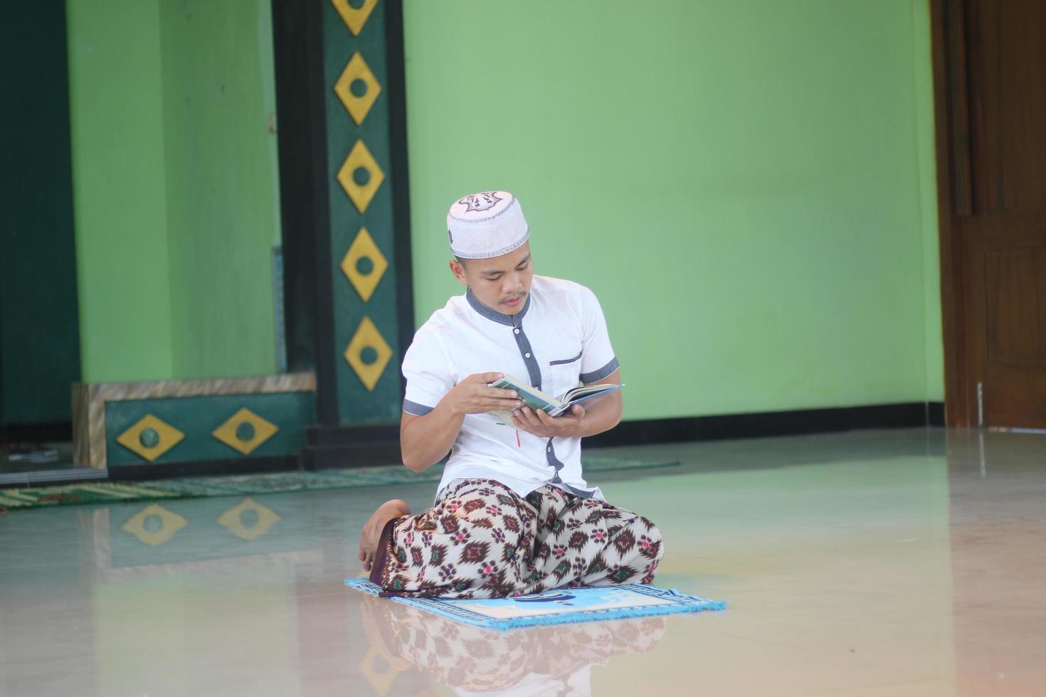 Young asian muslim praying in the mosque photo