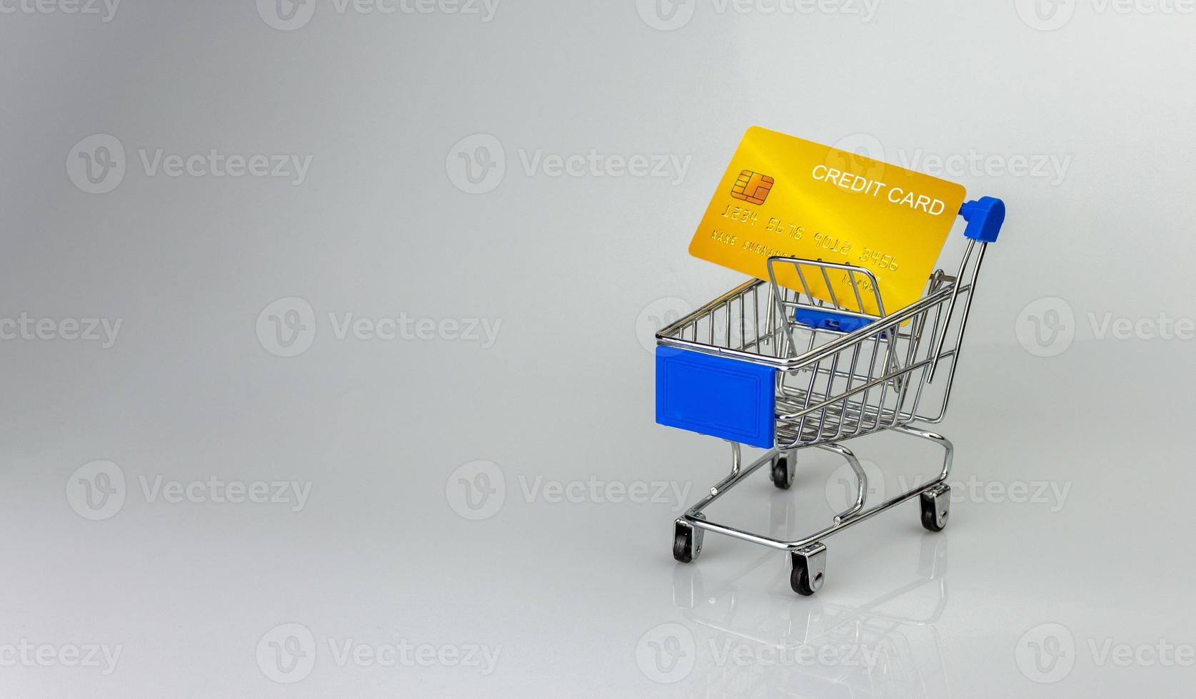 Shopping car and mockup credit card  on light and shadow background. shopping online concept. photo