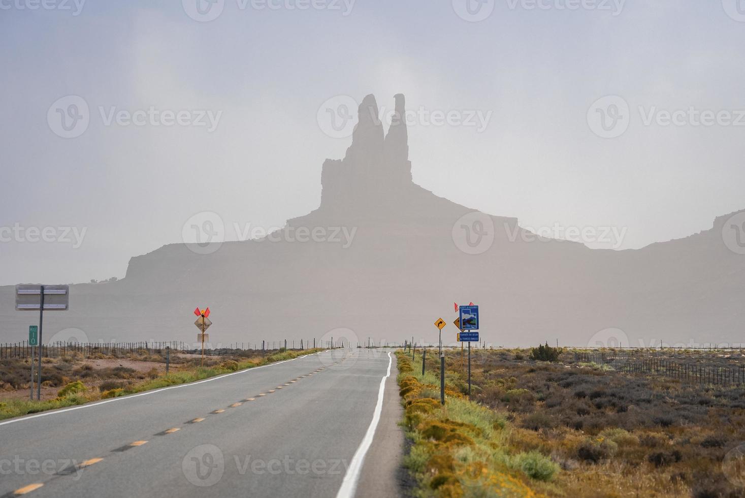 Signboards by highway leading towards geological features in Monument Valley photo