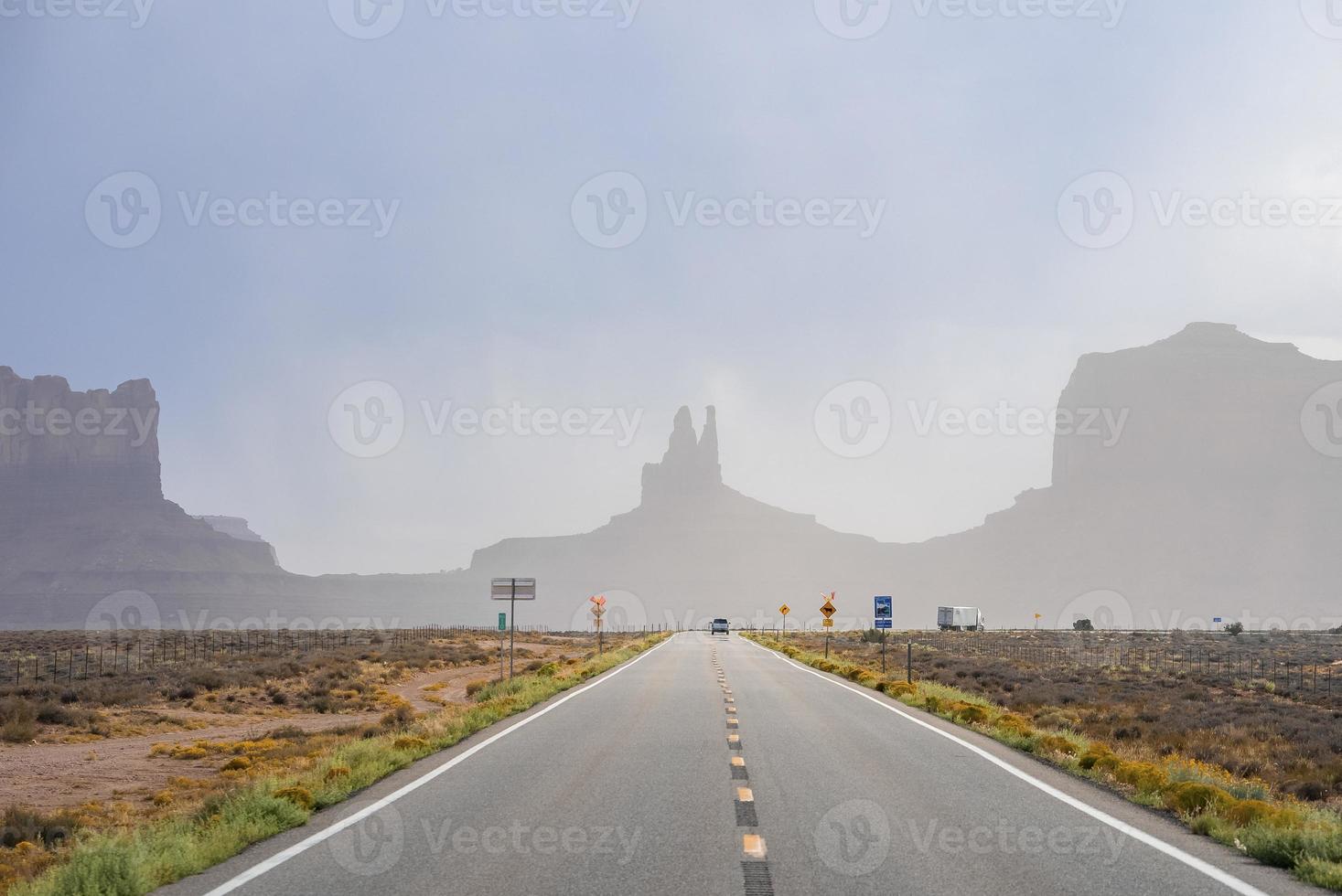 Highway leading towards geological features in Monument Valley desert photo