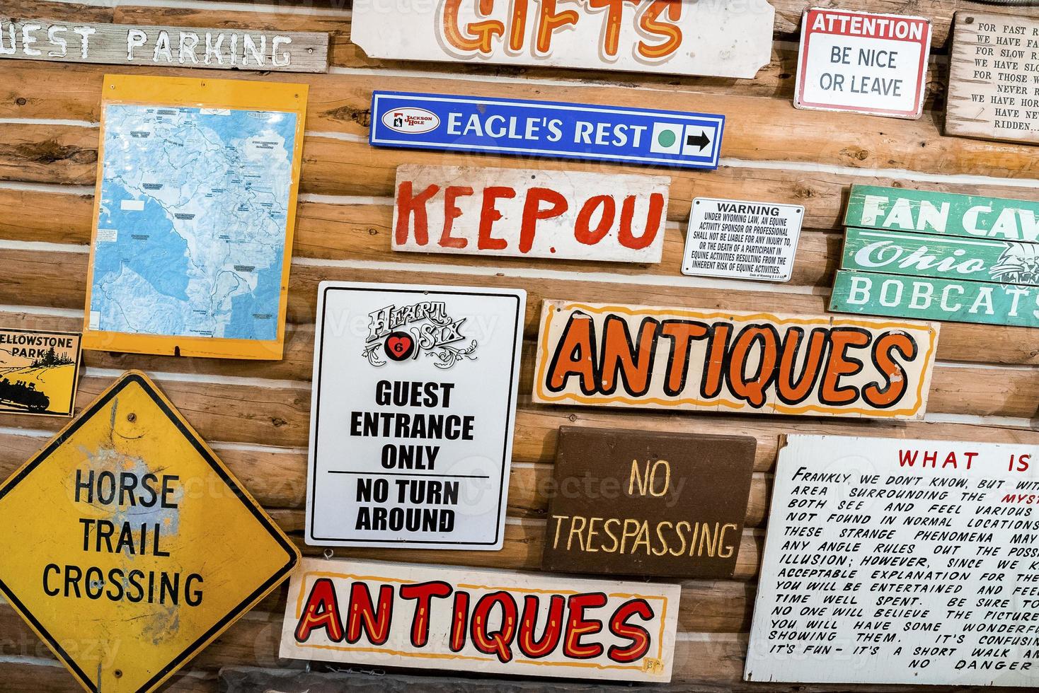 Various signboards with text on wooden wall of restaurant at Yellowstone park photo