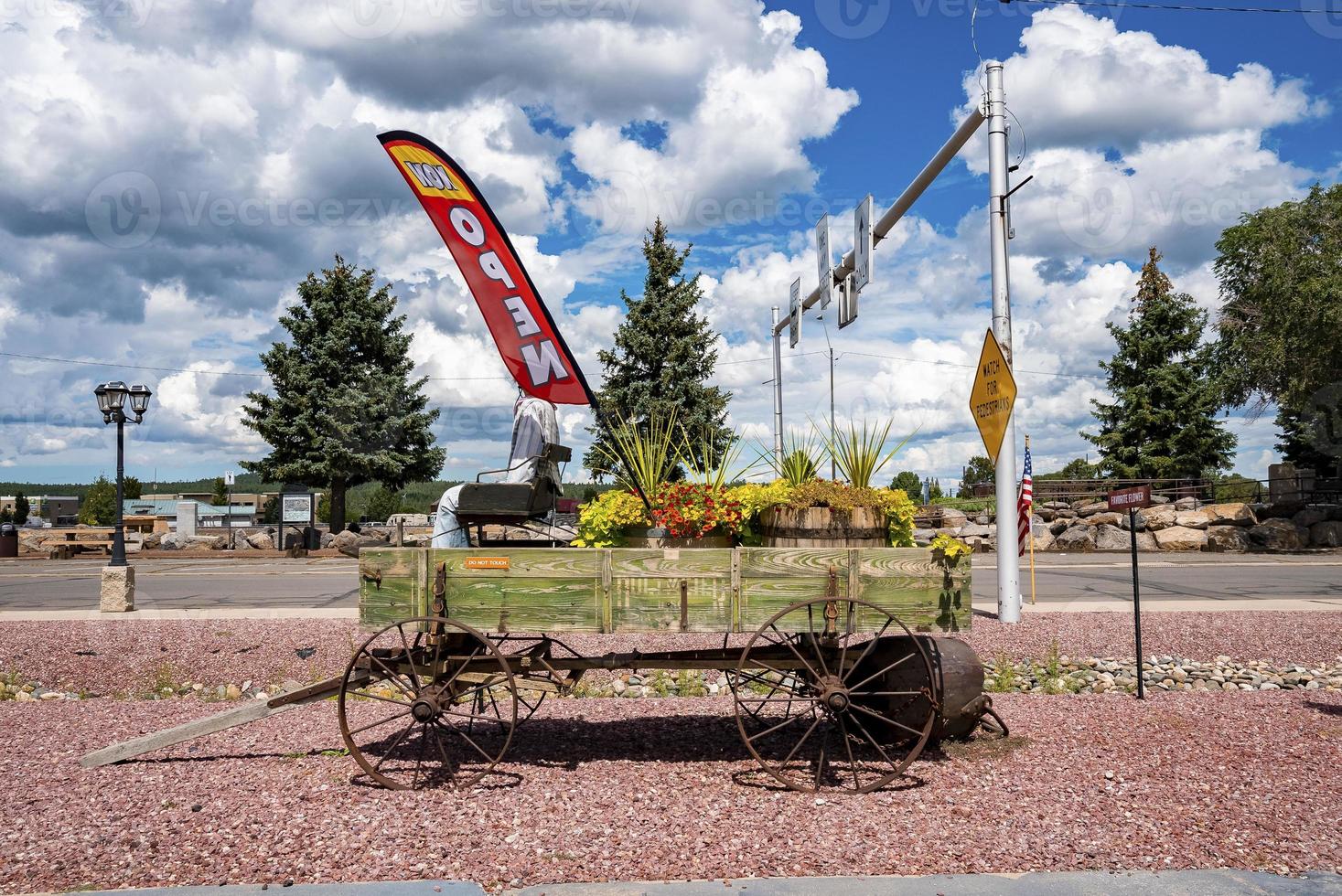 Flowers decorated on old wagon at entrance of shop by road in old historic city photo