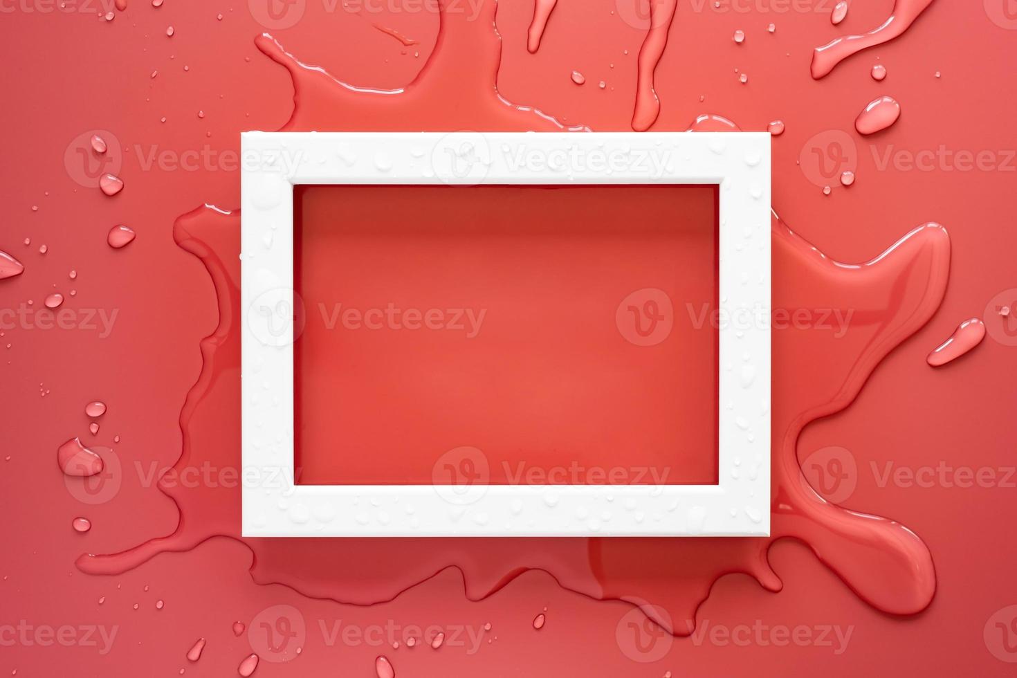 White rectangular empty frame on clean spilled water, on a pink background. Copy space. Top view. photo