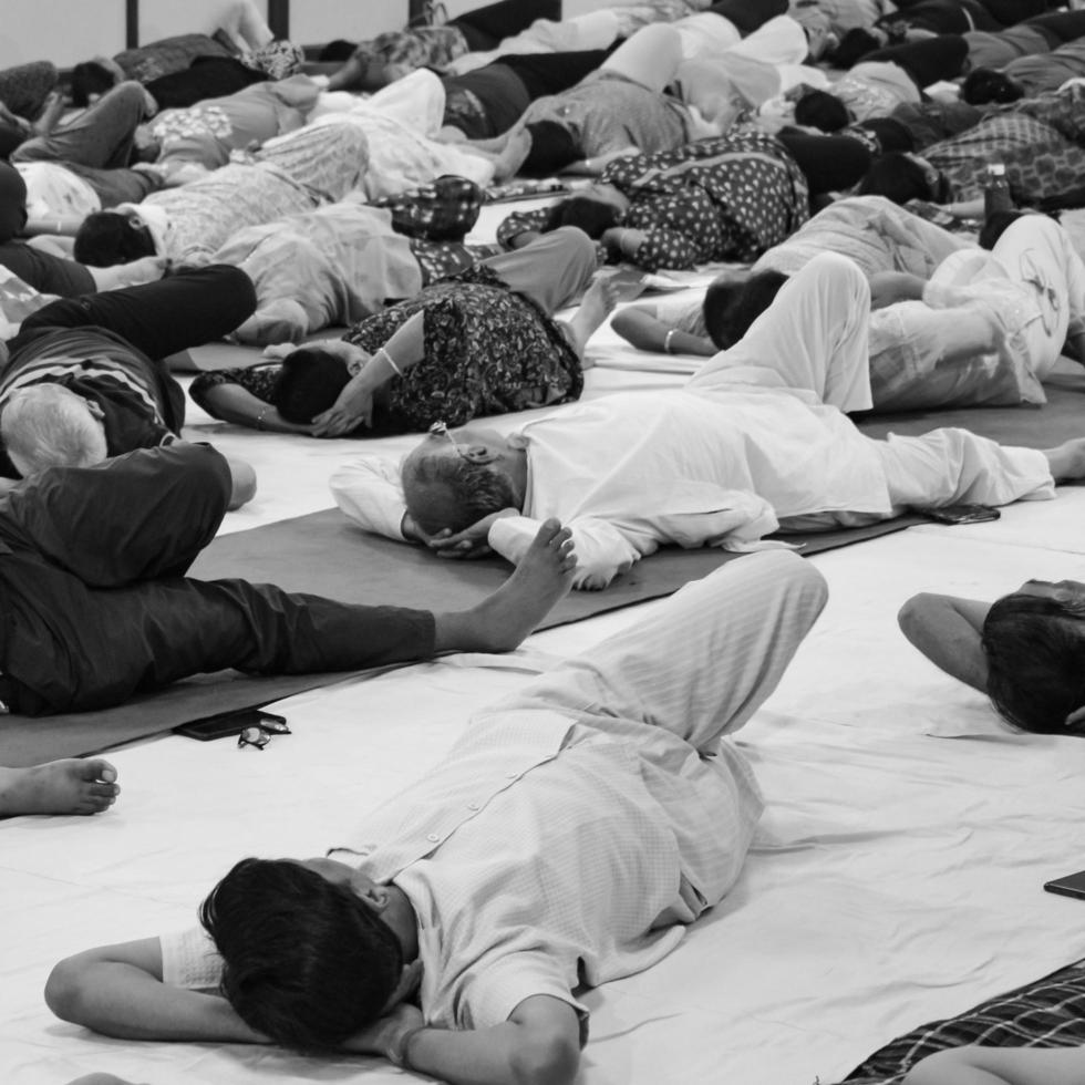 Delhi, India, June 19 2022-Group Yoga exercise session for people of different age groups in Balaji Temple,Vivek Vihar, International Yoga Day, Big group of adults attending yoga class-Black and White photo