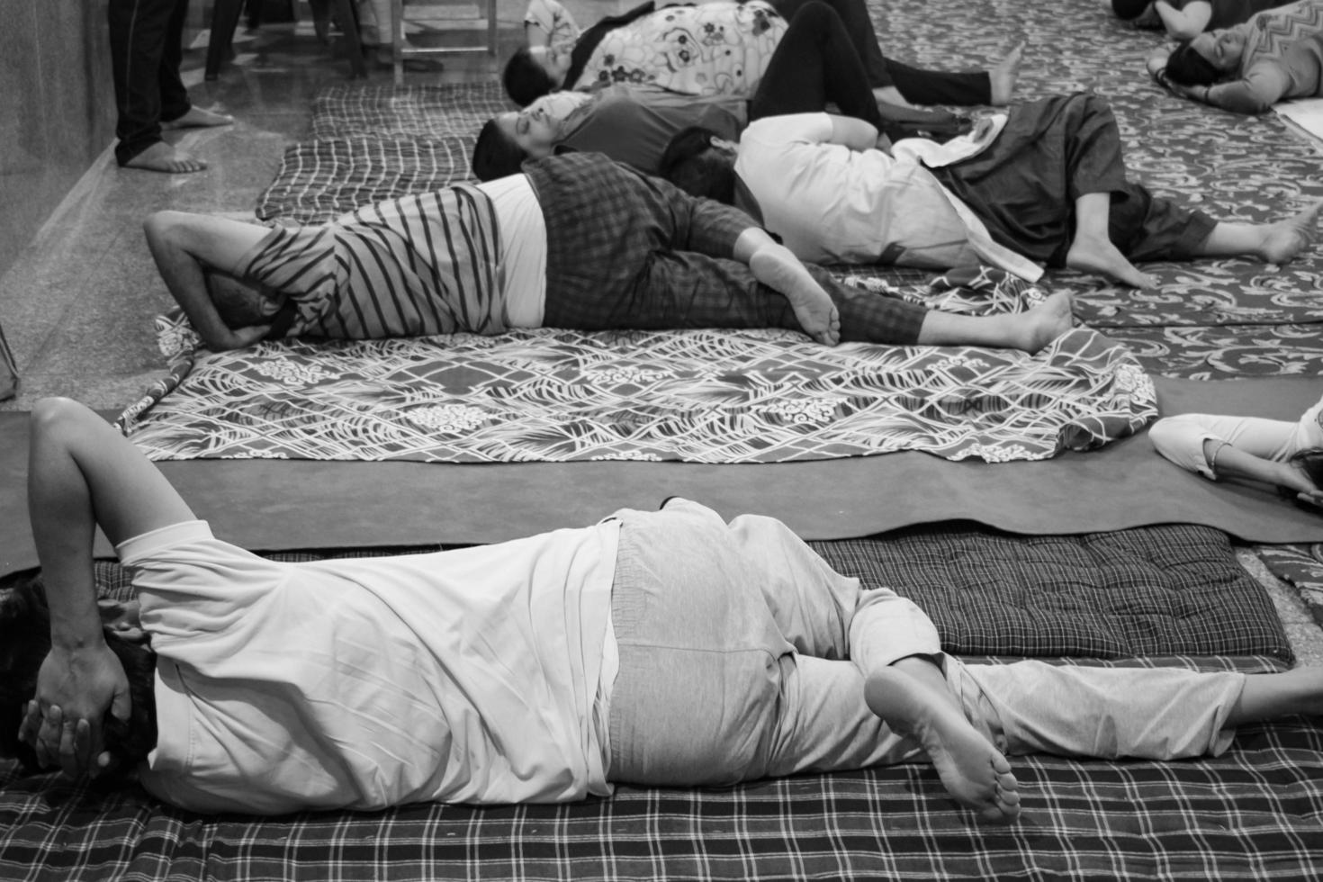 Delhi, India, June 19 2022-Group Yoga exercise session for people of different age groups in Balaji Temple,Vivek Vihar, International Yoga Day, Big group of adults attending yoga class-Black and White photo