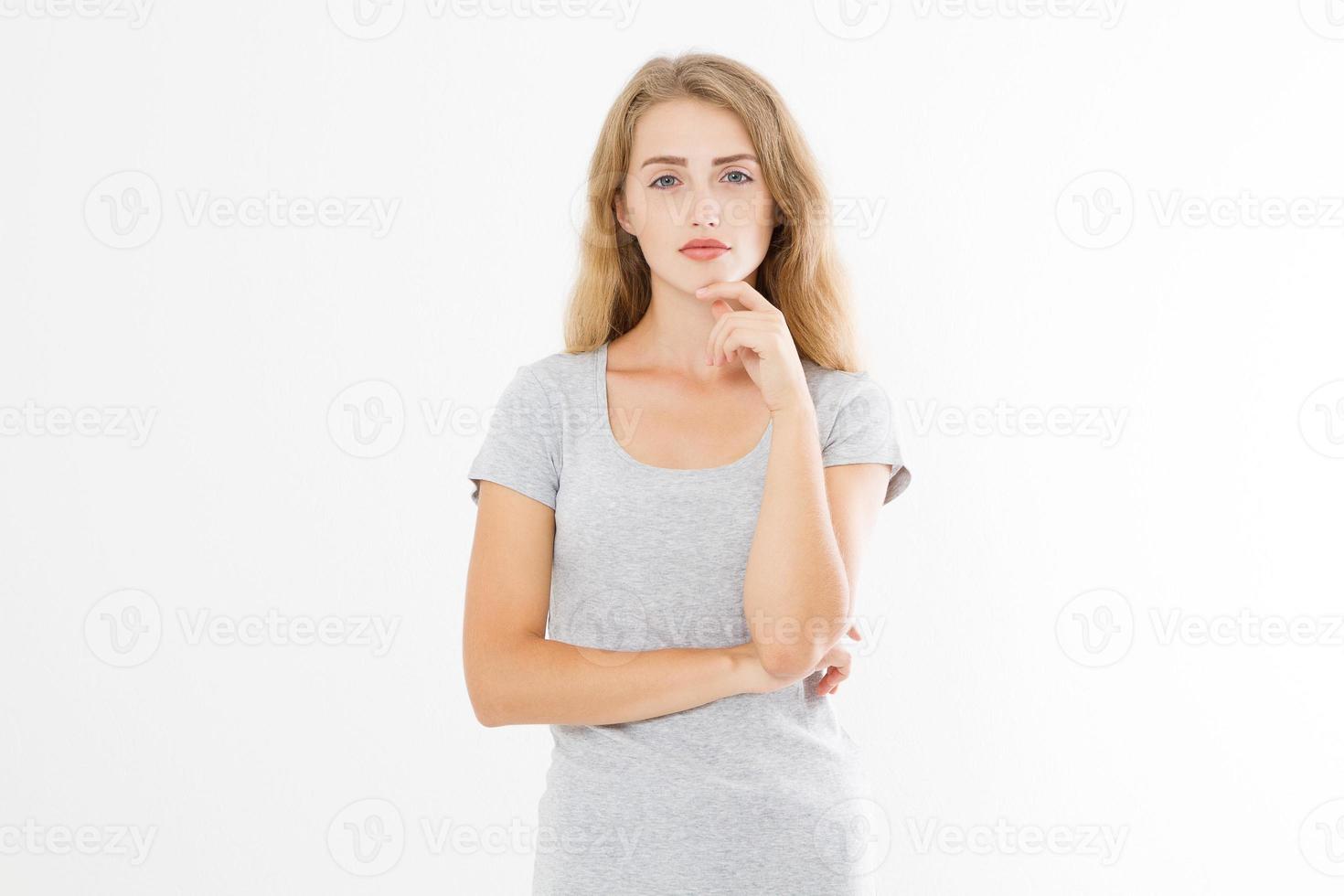 Thinking young blonde woman in blank template t shirt isolated on white background. Skin and hair care. Copy space and mock up photo