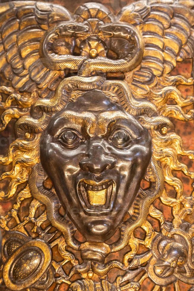 Medusa monster. Face of the Gorgon, gothic symbol of evil with snakes on hair. photo
