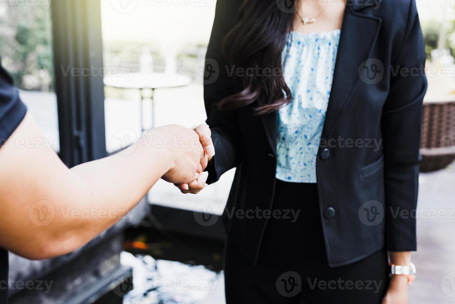 Business people handshake in corporate office showing professional agreement on a financial deal contract. photo