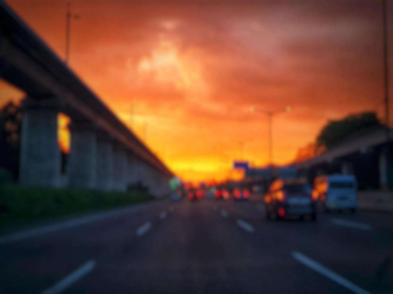 Defocused blurred abstract background of traffic jam at night in east Jakarta. The rear view, the red and yellow lights or the brake lights of the cars are on. photo