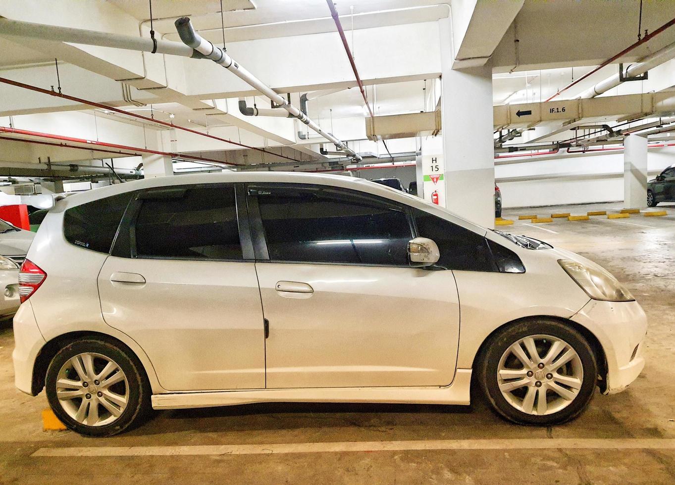 Side view of a white Honda Jazz. photo